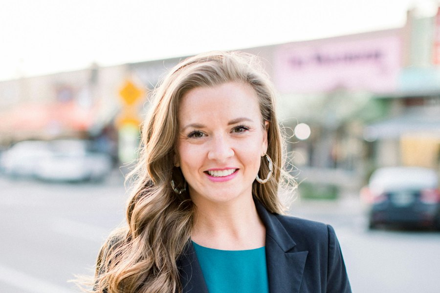 A businesswoman smiling, dressed for a work trip