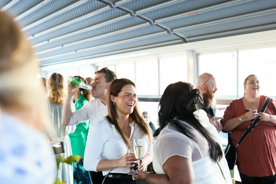 Guests mingling with drinks at a winery event