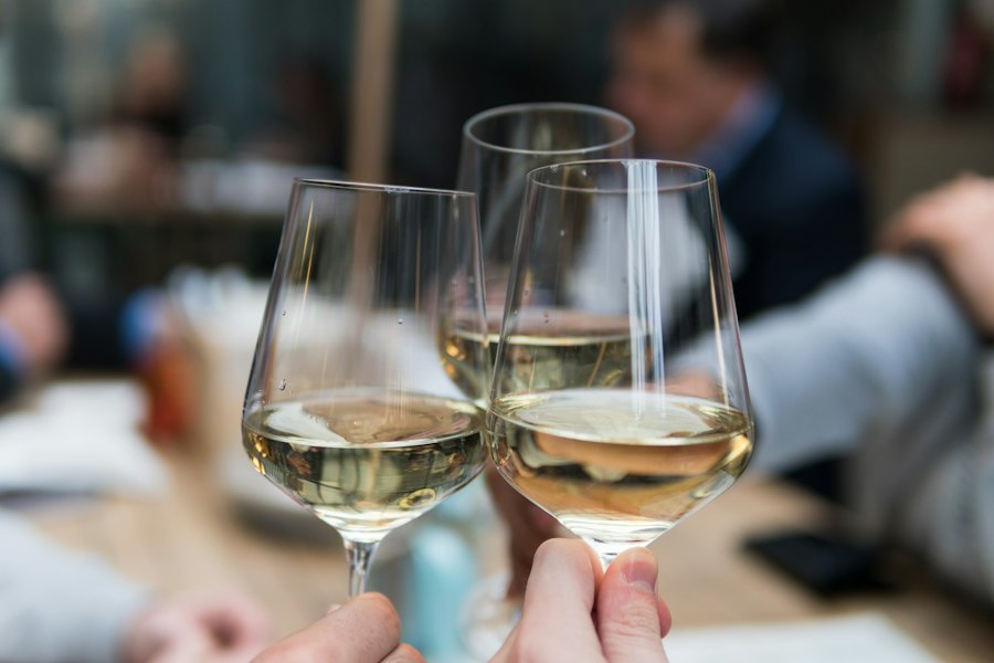 Three people raising crystal glasses together